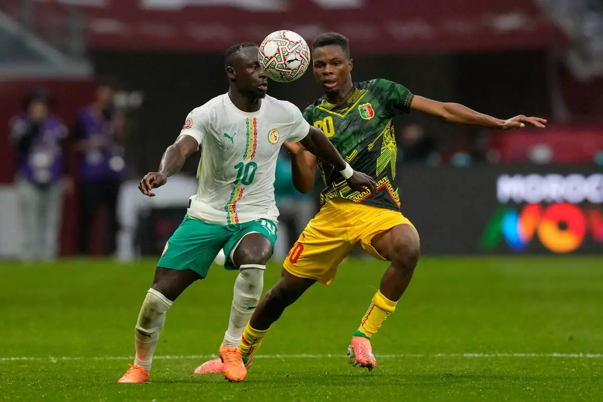 Senegal's Sadio Mane, left, and Mali's Mamadou Sangare fight for the ball during the Africa Cup of Nations quarterfinal soccer match between Senegal and Mali in Tangier, Morocco, Friday, Jan. 9, 2026. (AP Photo/Themba Hadebe)