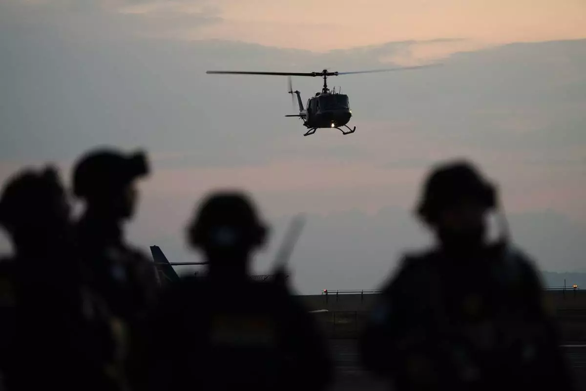 A police helicopter lands at an Air Force base carrying a shipment of drugs seized at a Guatemalan Pacific port, in Guatemala City, Monday, Jan. 26, 2026. (AP Photo/Moises Castillo)