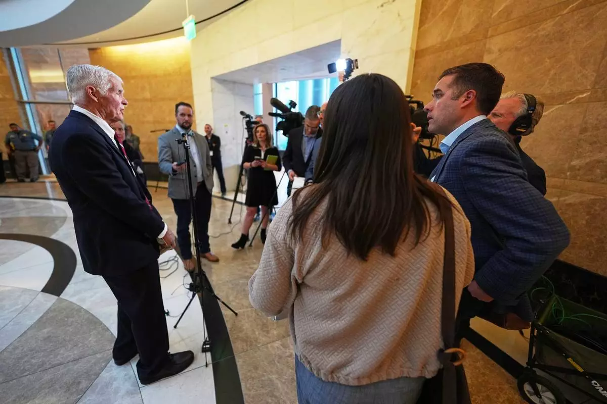 Attorney John Case, left, talks to reporters after a hearing to urge a state appeals court to overturn the convictions against former Colorado elections clerk and Donald Trump ally Tina Peters for orchestrating a data breach of her county's elections equipment Wednesday, Jan. 14, 2026, in Denver. (AP Photo/David Zalubowski)