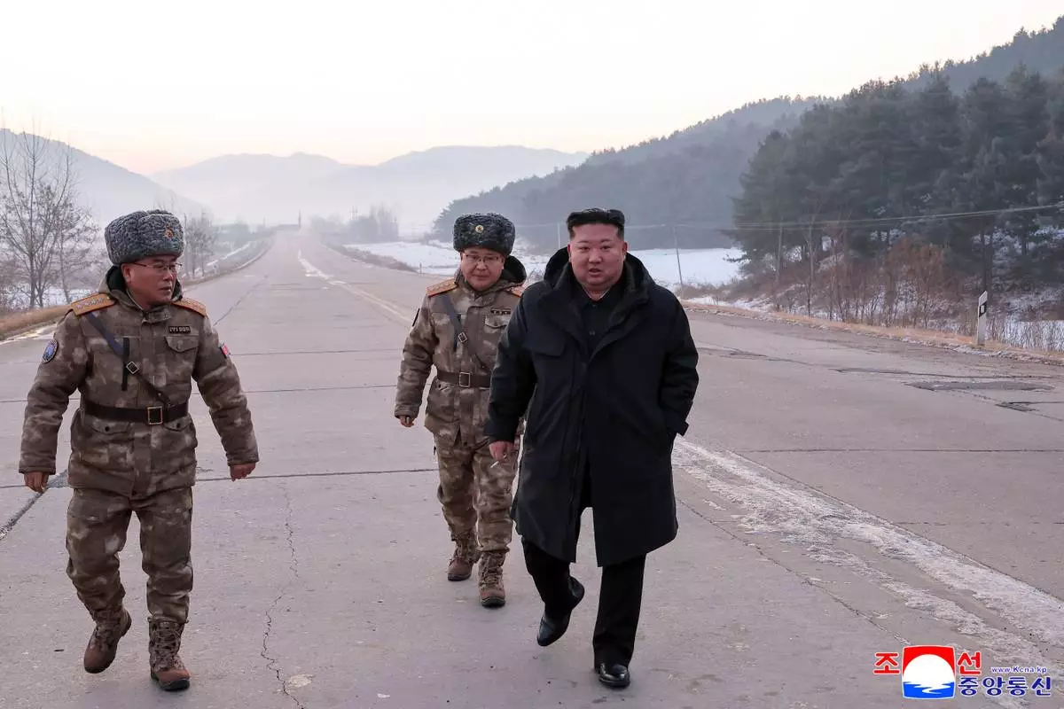 In this photo provided by the North Korean government, leader Kim Jong Un walks on a road as he inspects test-flights of hypersonic missiles, in Pyongyang, North Korea, Sunday, Jan. 4, 2026. Independent journalists were not given access to cover the event depicted in this image distributed by the North Korean government. The content of this image is as provided and cannot be independently verified. Korean language watermark on image as provided by source reads: "KCNA" which is the abbreviation for Korean Central News Agency. (Korean Central News Agency/Korea News Service via AP)