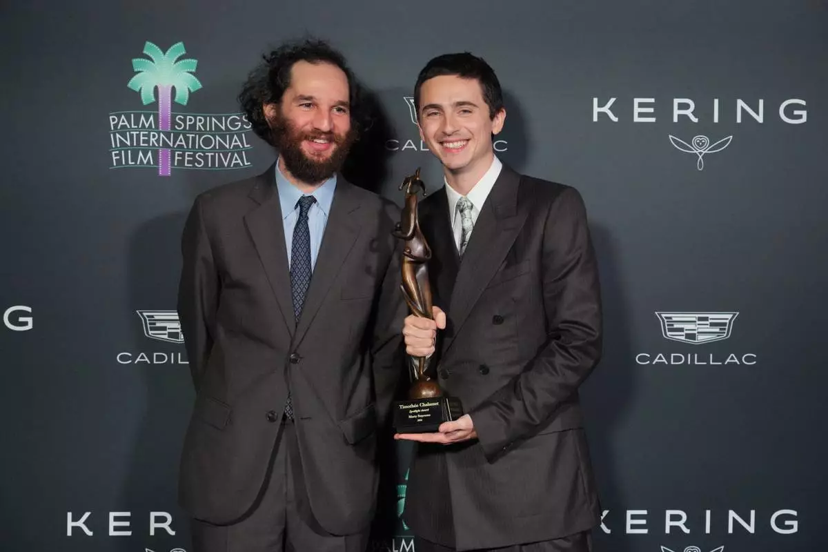 Josh Safdie, left, and Timothee Chalamet, with the spotlight actor of the year award for "Marty Supreme," pose in the press room during the 37th Palm Springs International Film Festival Film Awards on Saturday, Jan. 3, 2026 at Palm Springs Convention Center in Palm Springs, Calif. (Photo by Jordan Strauss/Invision/AP)