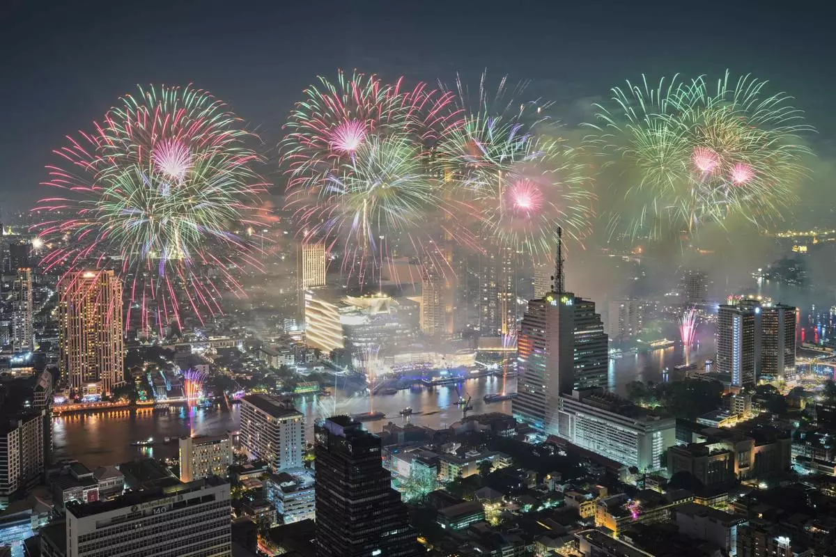FILE - Fireworks explode over Chao Phraya River during New Year celebrations in Bangkok, Thailand, Jan. 1, 2026. (AP Photo/Sakchai Lalit, File)