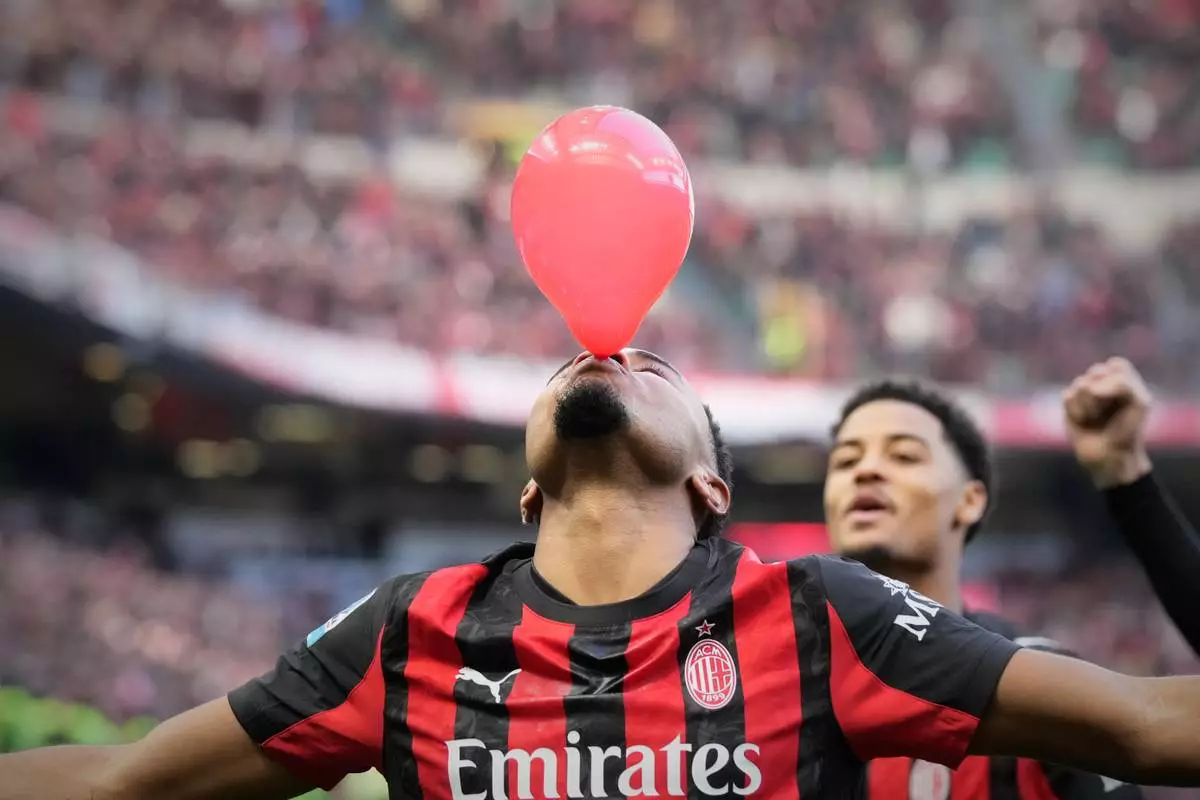 FILE - AC Milan's Christopher Nkunku celebrates after scoring his side's second goal from a penalty kick during a Serie A soccer match between AC Milan and Hellas Verona, in Milan, Italy, Dec. 28, 2025. (AP Photo/Luca Bruno, File)