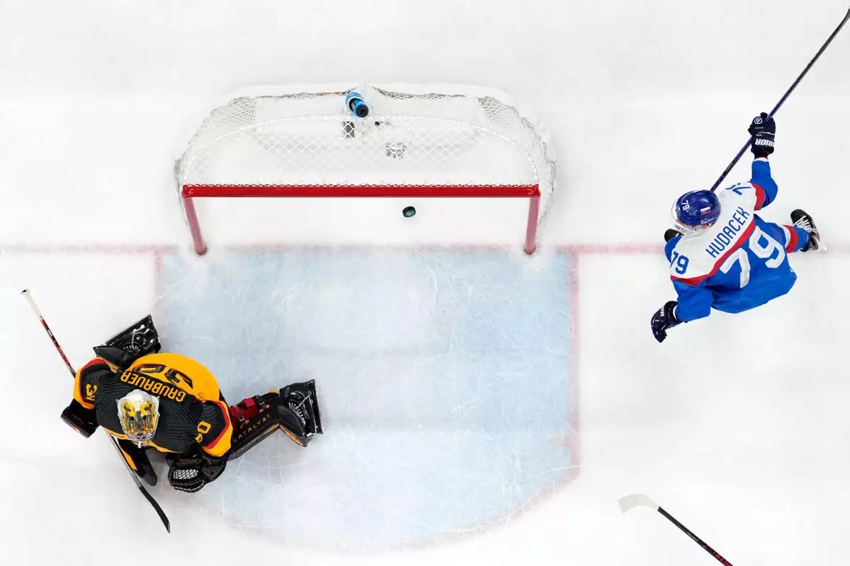 Slovakia's Libor Hudacek (79) celebrates after Slovakia's Dalibor Dvorsky, not seen, scored his side's fourth goal during a men's ice hockey quarterfinal game between Slovakia and Germany at the 2026 Winter Olympics, in Milan, Italy, Wednesday, Feb. 18, 2026. (AP Photo/Petr David Josek)