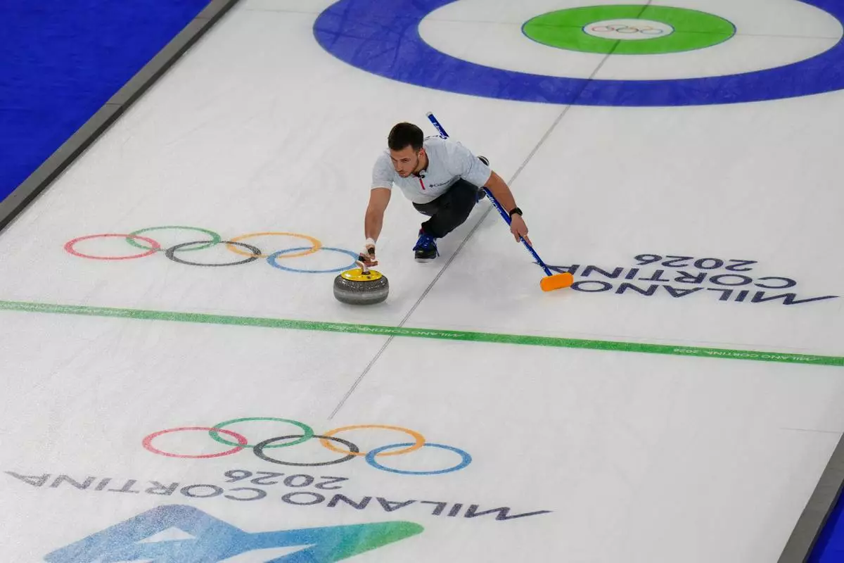 United States' Korey Dropkin delivers the stone during a curling mixed doubles round robin session against Britain at the 2026 Winter Olympics, in Cortina d'Ampezzo, Italy, Saturday, Feb. 7, 2026. (AP Photo/David J. Phillip)