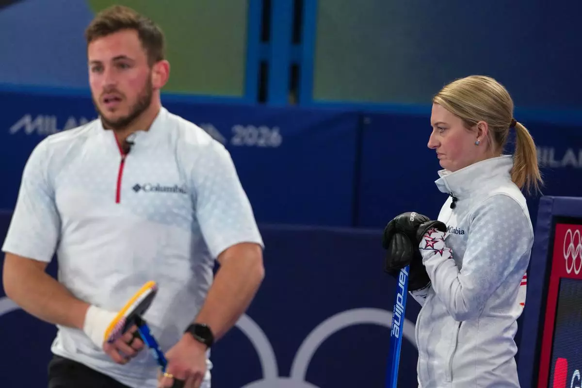 United States' Cory Thiesse and Korey Dropkin look on during the mixed doubles round robin phase of the curling competition against Britain, at the 2026 Winter Olympics, in Cortina d'Ampezzo, Italy, Saturday, Feb. 7, 2026. (AP Photo/Misper Apawu)