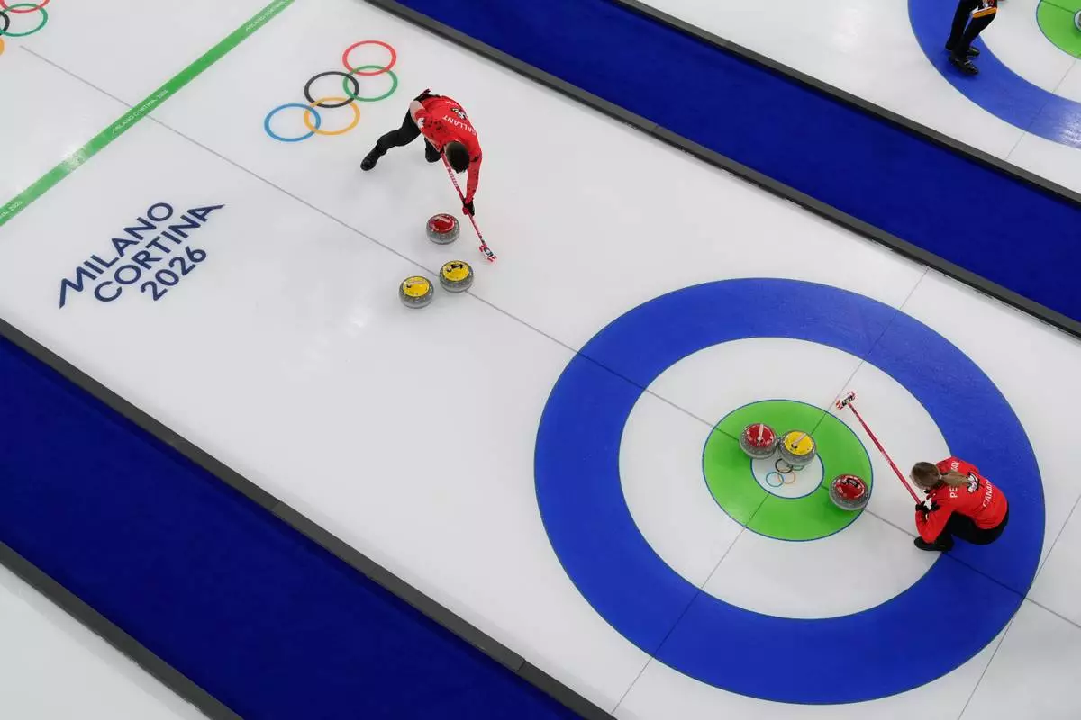 Canada's Brett Gallant and Jocelyn Peterman compete during a curling mixed doubles session against Czechia at the 2026 Winter Olympics in Cortina d'Ampezzo, Italy, Wednesday, Feb. 4, 2026. (AP Photo/David J. Phillip)