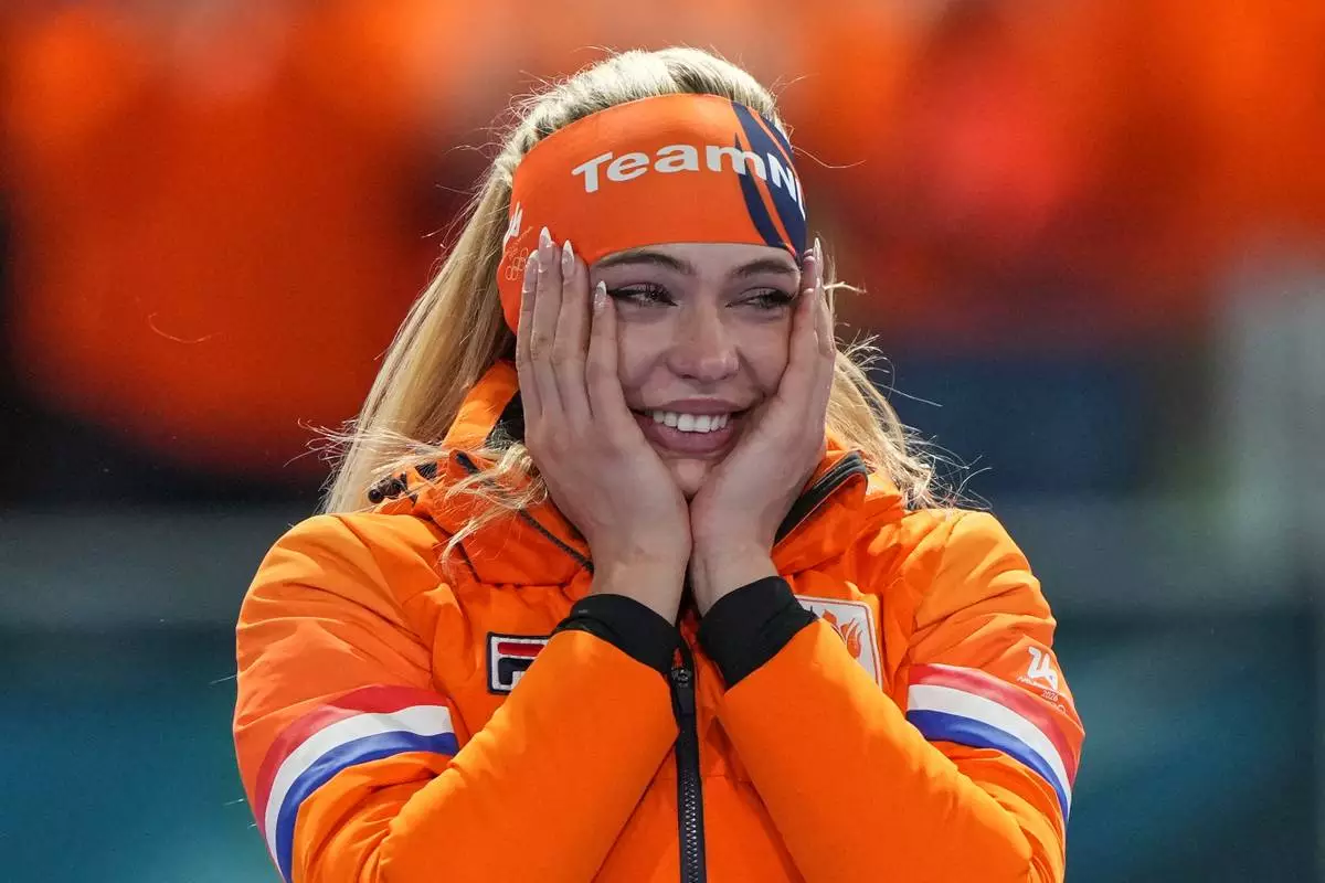 Gold medallist Jutta Leerdam of the Netherlands reacts on the podium of the women's 1,000 meters speedskating race at the 2026 Winter Olympics, in Milan, Italy, Monday, Feb. 9, 2026. (AP Photo/Antonio Calanni)