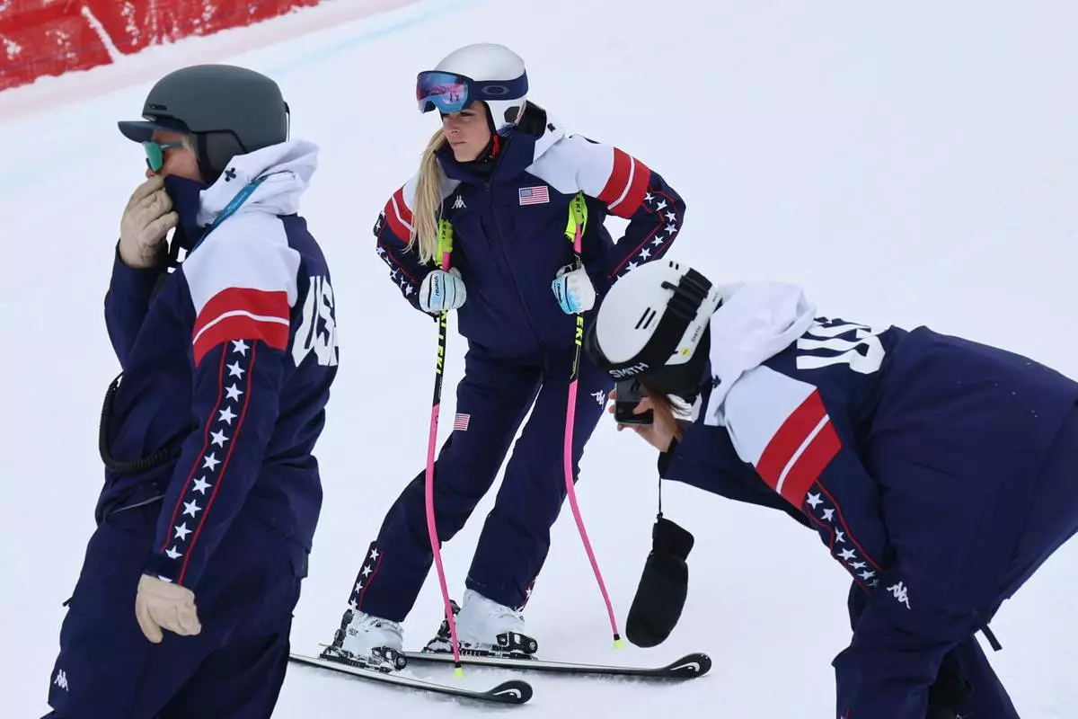 United States' Lindsey Vonn, center, concentrates ahead of an alpine ski, women's downhill official training, at the 2026 Winter Olympics, in Cortina d'Ampezzo, Italy, Friday, Feb. 6, 2026. (AP Photo/Marco Trovati)