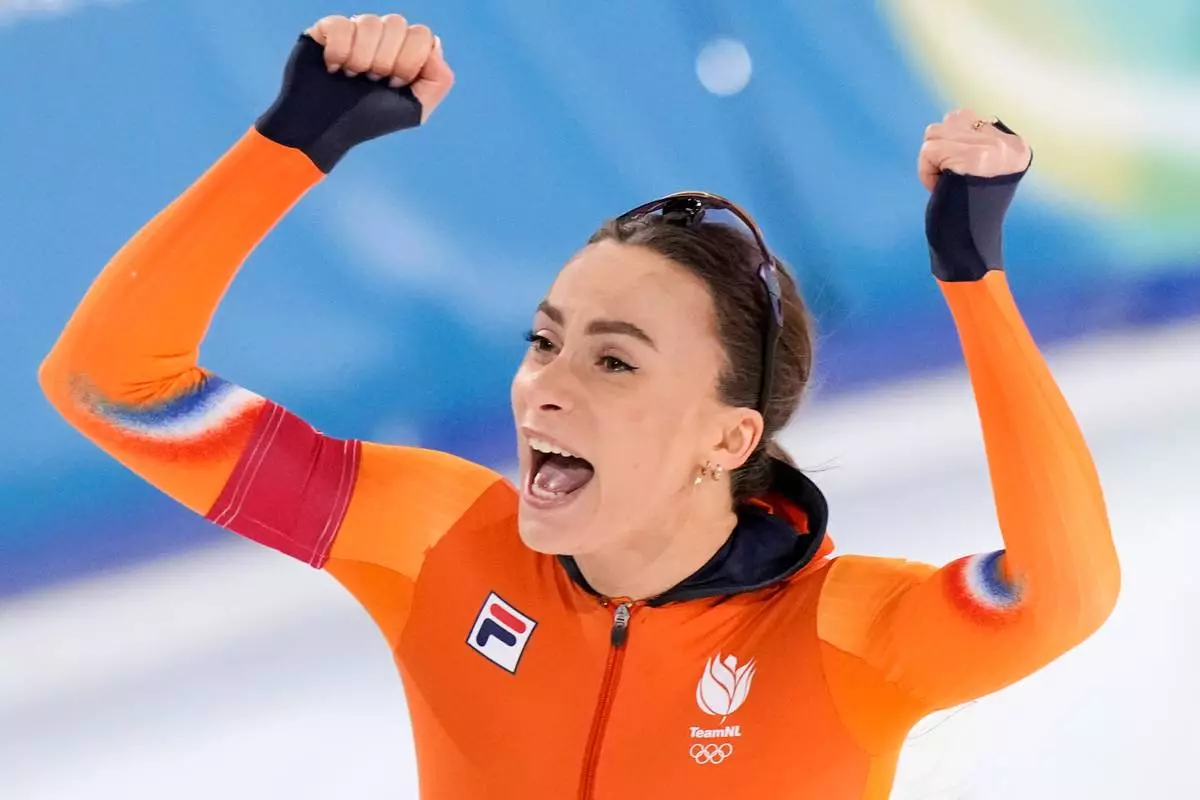 Femke Kok of the Netherlands celebrates winning the gold medal in the women's 500 meters speedskating race at the 2026 Winter Olympics, in Milan, Italy, Sunday, Feb. 15, 2026. (AP Photo/Luca Bruno)
