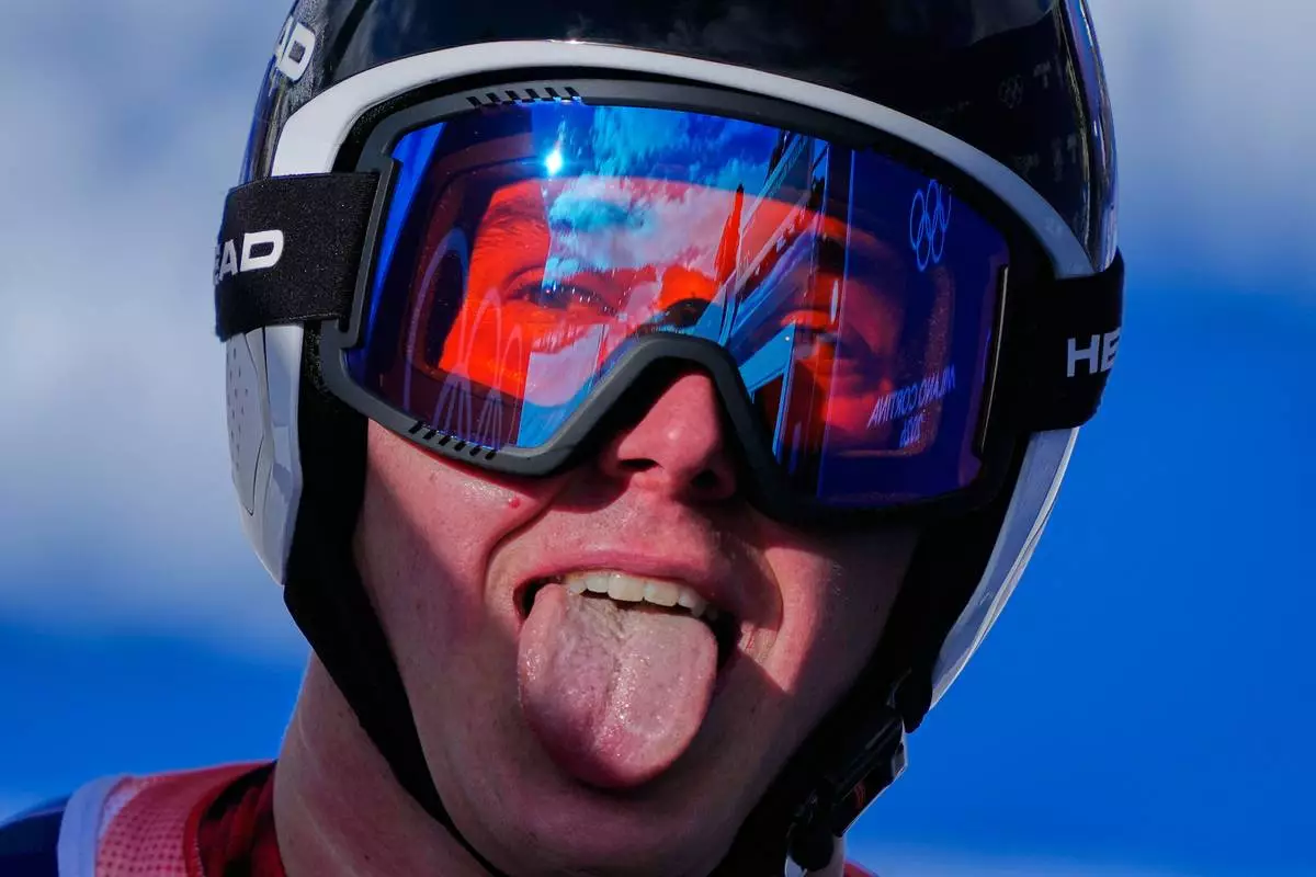Switzerland's Franjo von Allmen sticks his tongue out at the finish area, during a men's super-G race, at the 2026 Winter Olympics, in Bormio, Italy, Wednesday, Feb.11, 2026. (AP Photo/Julia Demaree Nikhinson)