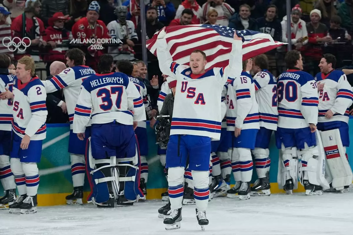 United States celebrate after defeating Canada in a men's ice hockey gold medal game between Canada and the United States at the 2026 Winter Olympics, in Milan, Italy, Sunday, Feb. 22, 2026. (AP Photo/Petr David Josek)