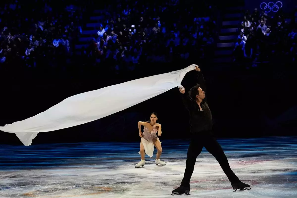 Madison Chock and Evan Bates of the United States perform during the figure skating exhibition at the 2026 Winter Olympics, in Milan, Italy, Saturday, Feb. 21, 2026. (AP Photo/Ashley Landis)