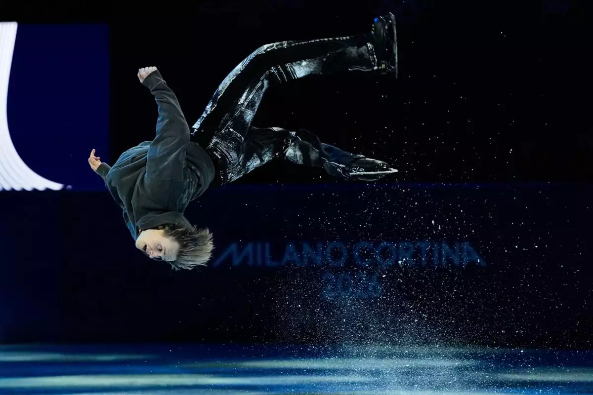 Ilia Malinin of the United States does a back flip during his performance in the figure skating exhibition at the 2026 Winter Olympics, in Milan, Italy, Saturday, Feb. 21, 2026. (AP Photo/Ashley Landis)