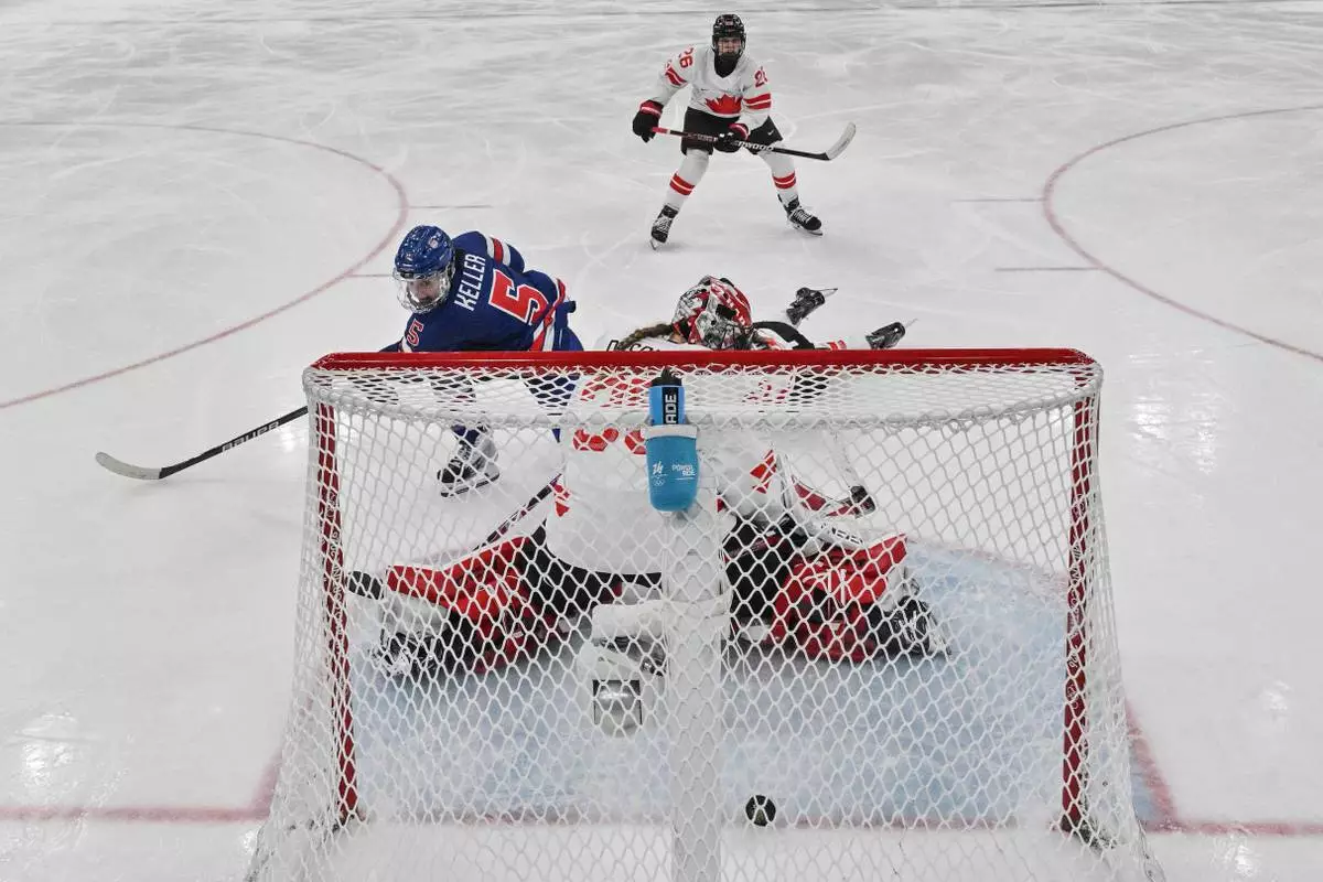 United States' Megan Keller (5) scores the winning goal in the women's ice hockey gold medal game between the United States and Canada at the 2026 Winter Olympics, in Milan, Italy, Thursday, Feb. 19, 2026. (Alexander Nemenov/Pool Photo via AP)