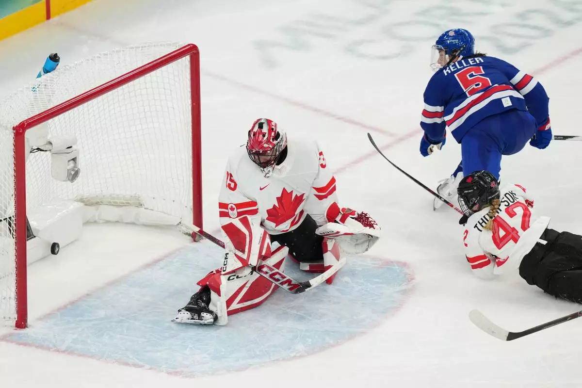 United States' Megan Keller (5) scores the winning goal against Canada goalkeeper Ann-Renee Desbiens (35) during the overtime period of the women's ice hockey gold medal game at the 2026 Winter Olympics, in Milan, Italy, Thursday, Feb. 19, 2026. (AP Photo/Carolyn Kaster)