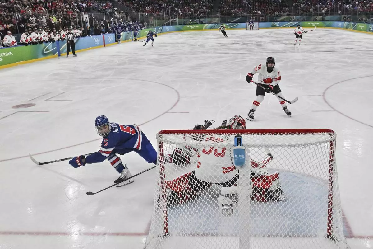 United States' Megan Keller (5) scores the winning goal during the women's ice hockey gold medal game between the United States and Canada at the 2026 Winter Olympics, in Milan, Italy, Thursday, Feb. 19, 2026. (Alexander Nemenov/Pool Photo via AP)