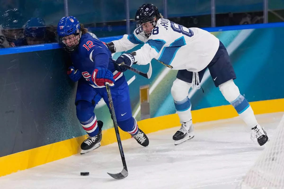 Finland's Ronja Savolainen, right, challenges United States' Kelly Pannek during a preliminary round match of women's ice hockey between the United States and Finland at the 2026 Winter Olympics, in Milan, Italy, Saturday, Feb. 7, 2026. (AP Photo/Petr David Josek)