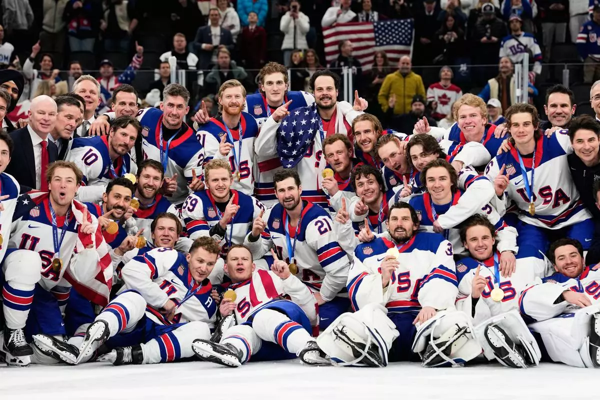 Gold medalists of the United States pose after the men's ice hockey gold medal game between Canada and the United States at the 2026 Winter Olympics, in Milan, Italy, Sunday, Feb. 22, 2026. (AP Photo/Hassan Ammar)