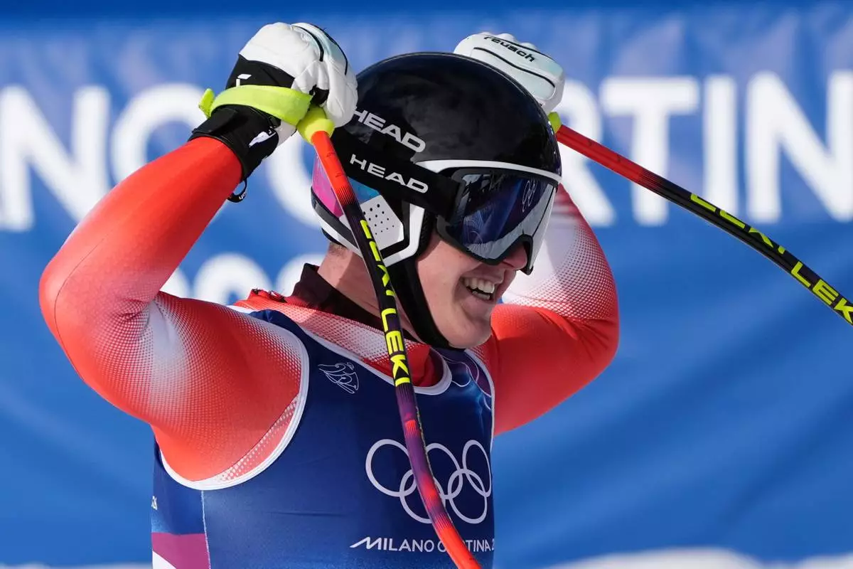 Switzerland's Franjo von Allmen celebrates at the finish area of an alpine ski men's downhill race, at the 2026 Winter Olympics, in Bormio, Italy, Saturday, Feb. 7, 2026. (AP Photo/Rebecca Blackwell)