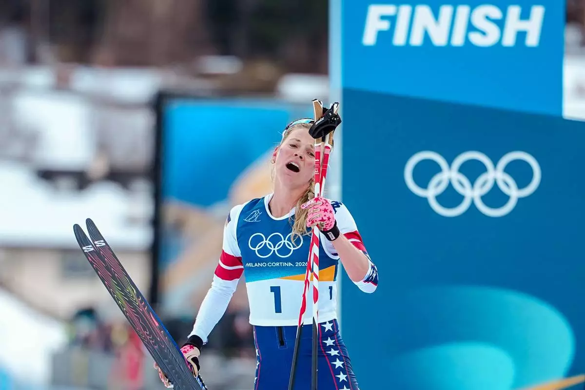 Jessie Diggins of the United States catches her breath after crossing the finish line in the cross country skiing women's 10km + 10km skiathlon at the 2026 Winter Olympics, in Tesero, Italy, Saturday, Feb. 7, 2026. (AP Photo/Matthias Schrader)