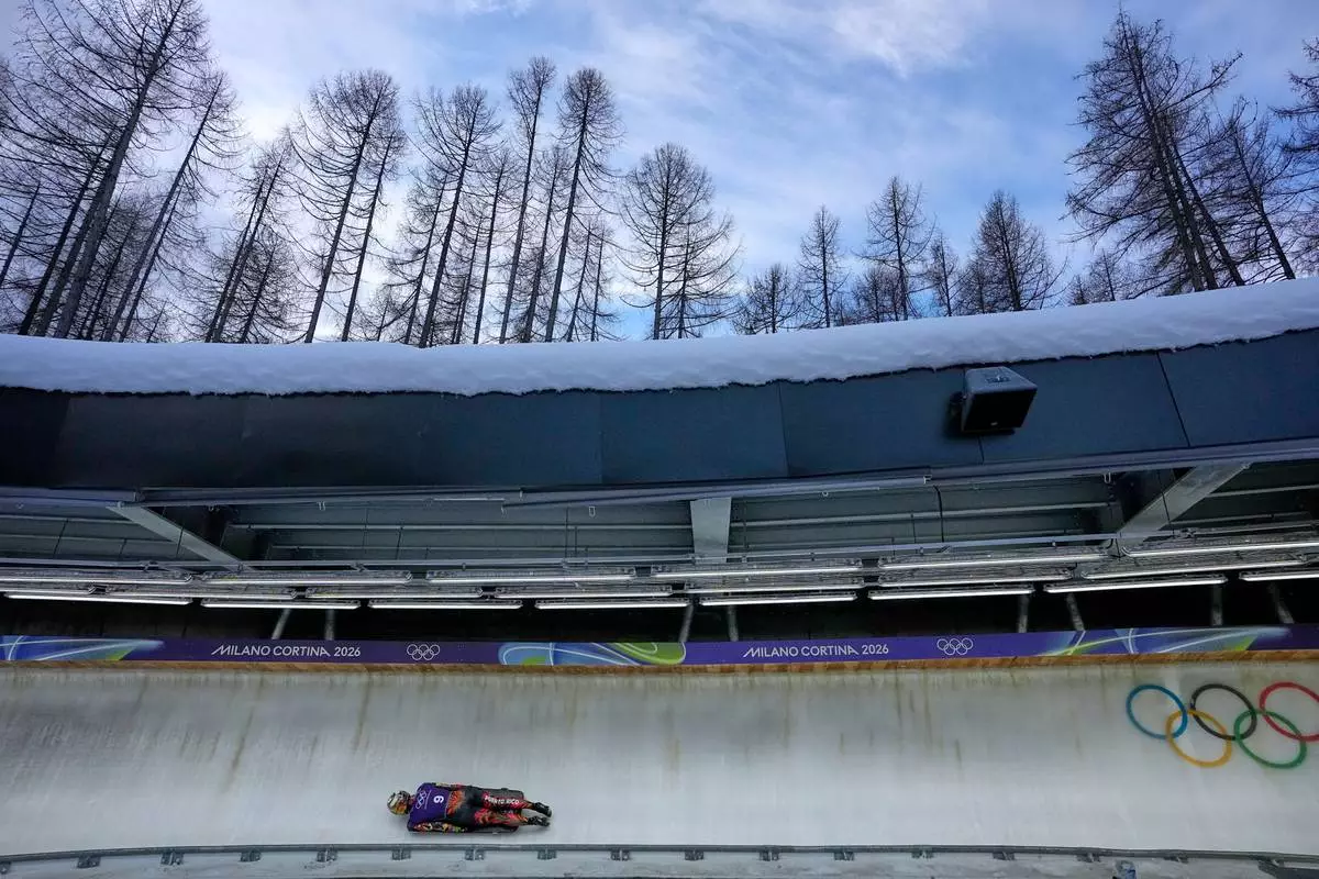 Puerto Rico's Kellie Delka slides down the track during a women's skeleton training session at the 2026 Winter Olympics, in Cortina d'Ampezzo, Italy, Monday, Feb. 9, 2026. (AP Photo/Aijaz Rahi)