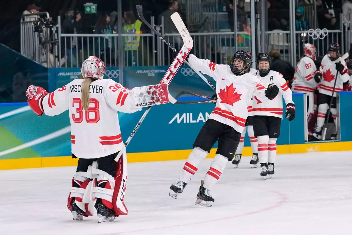 Canada's players celebrate after a preliminary round match of women's ice hockey between Switzerland and Canada at the 2026 Winter Olympics, in Milan, Italy, Saturday, Feb. 7, 2026. (AP Photo/Petr David Josek)