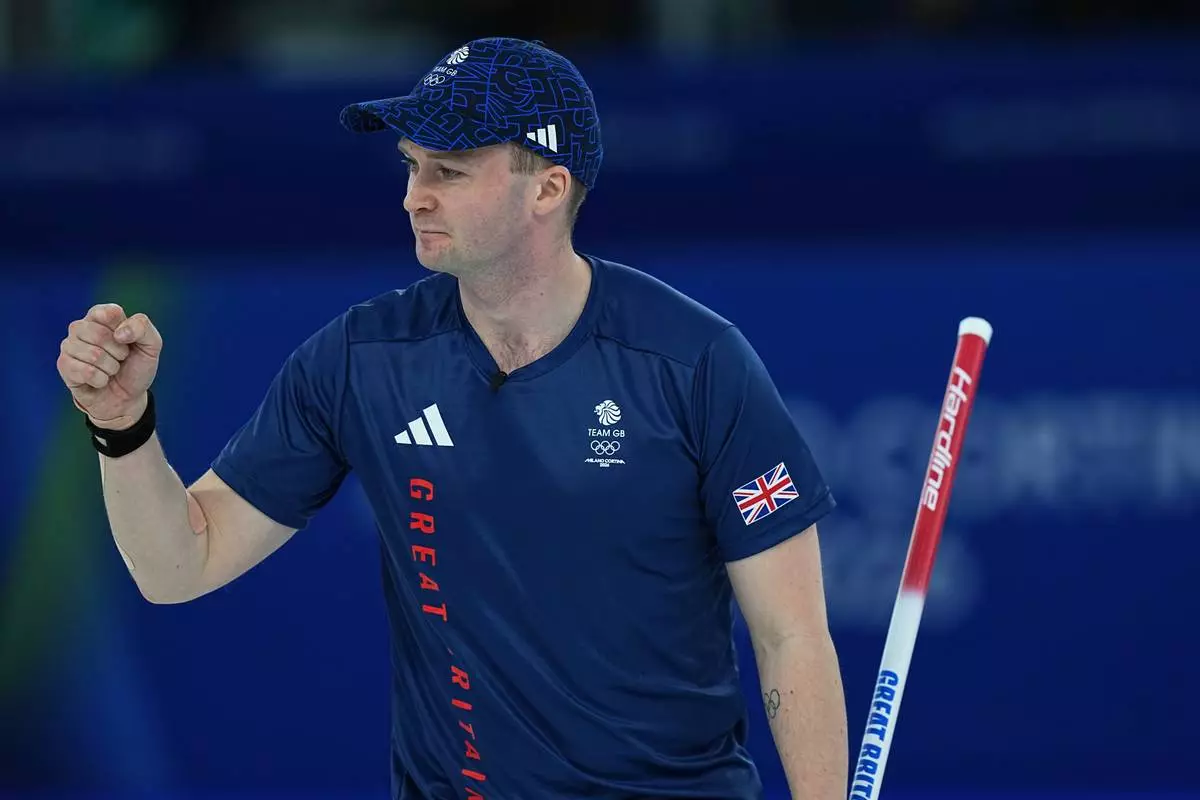 Britain's Bruce Mouat celebrates after winning the mixed doubles round robin phase of the curling competition against Canada at the 2026 Winter Olympics, in Cortina d'Ampezzo, Italy, Saturday, Feb. 7, 2026. (AP Photo/Fatima Shbair)