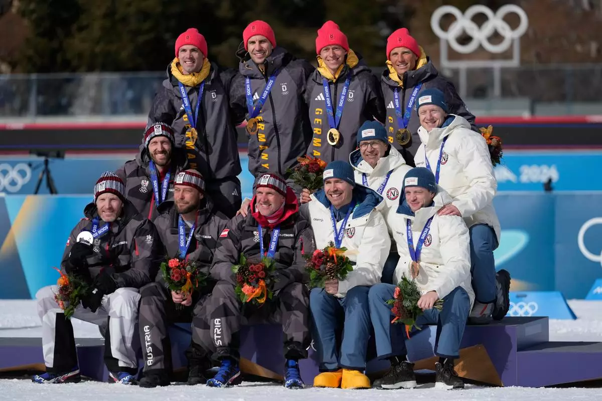 Germany's Erik Lesser, Daniel Boehm, Arnd Peiffer and Simon Schempp, back, pose with the gold medal for the men's 4x7.5-kilometer biathlon relay race from the 2014 Sochi Winter Olympics with Austria's Christoph Sumann, Daniel Mesotitsch, Simon Eder and Dominik Landertinger, silver medalists, and Norway's Tarjei Boe, Johannes Thingnes Boe, Ole Einar Bjoerndalen and Emil Hegle Svendsen, bronze medalists, front right, during a reallocation medals ceremony at the 2026 Winter Olympics in Anterselva, Italy, Sunday, Feb. 15, 2026. (AP Photo/Mosa'ab Elshamy)