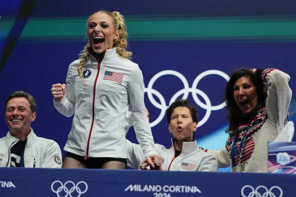 Emilea Zingas and Vadym Kolesnik of the United States react to their scores after competing during the rhythm dance in figure skating at the 2026 Winter Olympics, in Milan, Italy, Monday, Feb. 9, 2026. (AP Photo/Natacha Pisarenko)