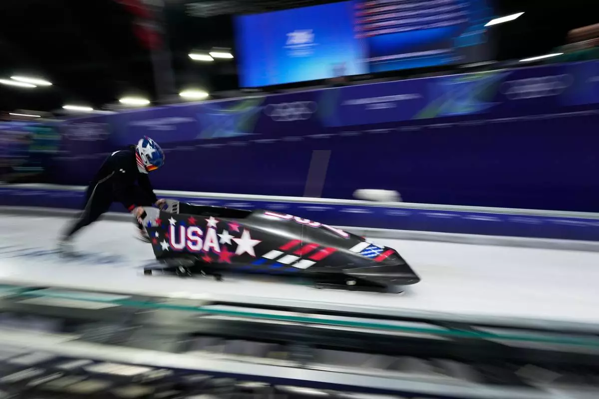 United States' Kaillie Armbruster Humphries starts for a women's monobob training session at the 2026 Winter Olympics, in Cortina d'Ampezzo, Italy, Friday, Feb. 13, 2026. (AP Photo/Alessandra Tarantino)