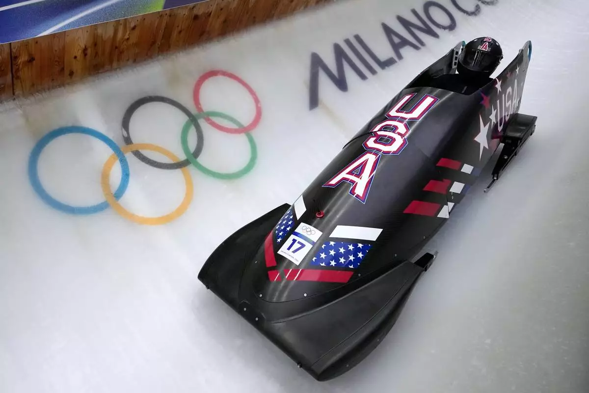 United States' Elana Meyers Taylor slides down the track during a women's monobob training session at the 2026 Winter Olympics, in Cortina d'Ampezzo, Italy, Thursday, Feb. 12, 2026. (AP Photo/Aijaz Rahi)