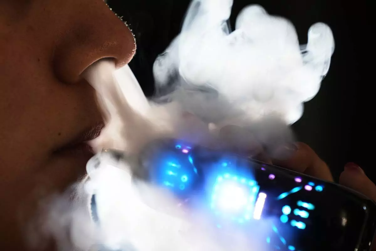 FILE - Ximena Fernandez vapes while working remotely from home in Mexico City, Jan. 30, 2026. (AP Photo/Marco Ugarte, File)