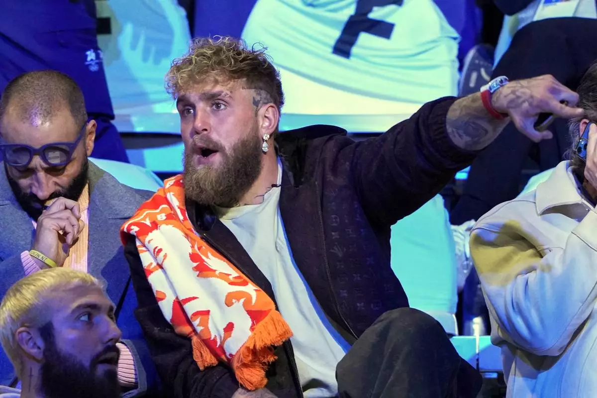 Jake Paul of the U.S., gestures as he waits to watch his fiancé Jutta Leerdam of the Netherlands compete in the women's 1,000 meters speedskating race at the 2026 Winter Olympics, in Milan, Italy, Monday, Feb. 9, 2026. (AP Photo/Antonio Calanni)