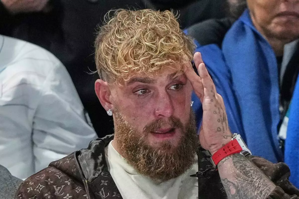 Jake Paul of the U.S. cries after his finale Jutta Leerdam of the Netherlands won the gold medal in the women's 1,000 meters speedskating race at the 2026 Winter Olympics, in Milan, Italy, Monday, Feb. 9, 2026. (AP Photo/Antonio Calanni)