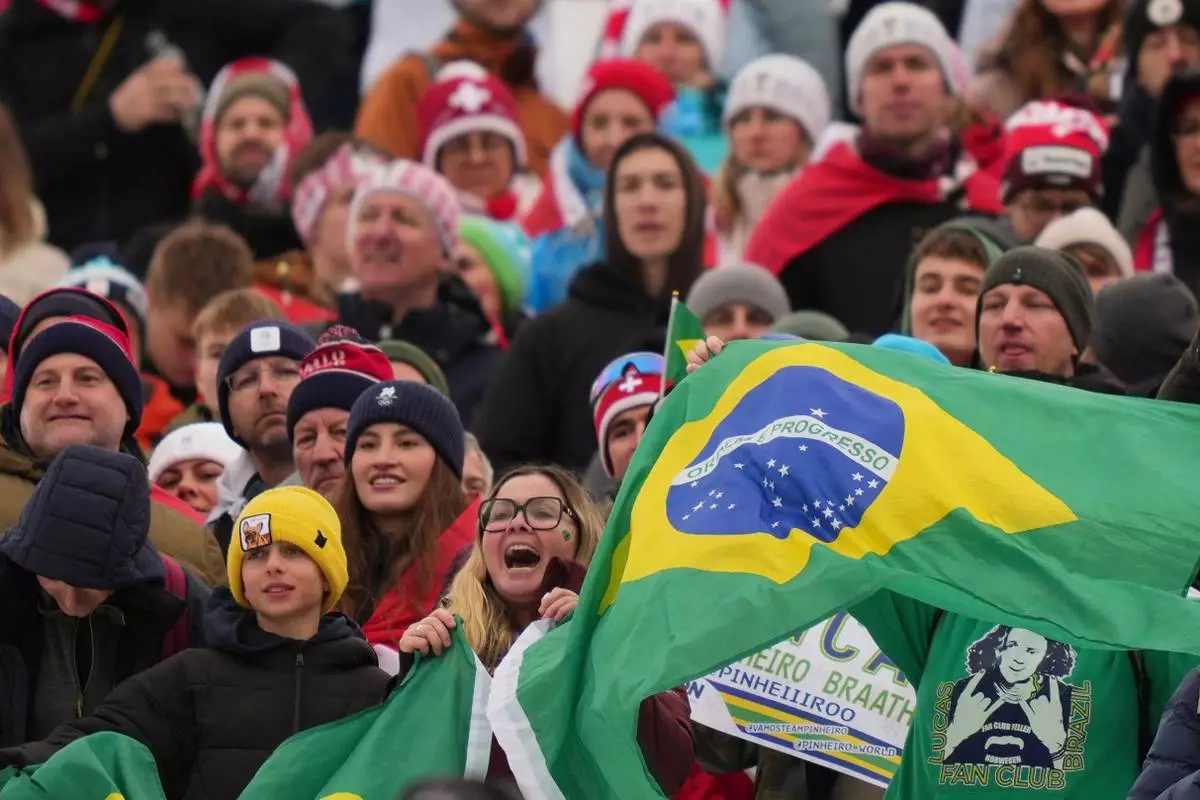 Brazilian fans cheer during the medal ceremony of an alpine ski, men's giant slalom race, won by Brazil's Lucas Pinheiro Braathen, at the 2026 Winter Olympics, in Bormio, Italy, Saturday, Feb. 14, 2026. (AP Photo/Julia Demaree Nikhinson)