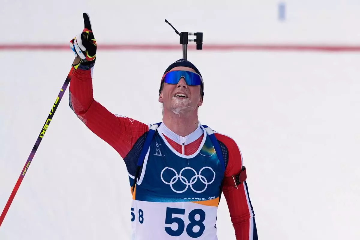 Johan-Olav Botn, of Norway, reacts after finishing the men's 20-kilometer individual biathlon race at the 2026 Winter Olympics in Anterselva, Italy, Tuesday, Feb. 10, 2026. (AP Photo/Andrew Medichini)