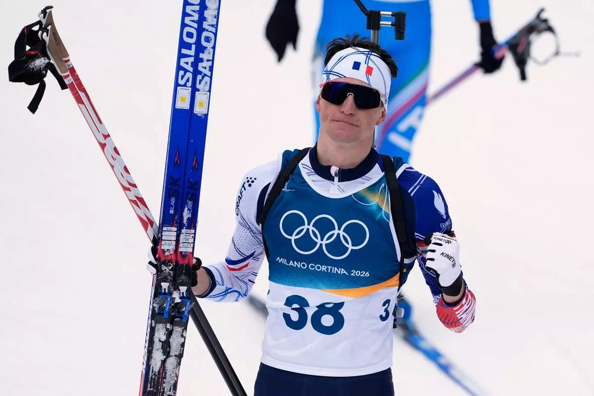 Eric Perrot, of France, reacts after finishing the men's 20-kilometer individual biathlon race at the 2026 Winter Olympics in Anterselva, Italy, Tuesday, Feb. 10, 2026. (AP Photo/Andrew Medichini)