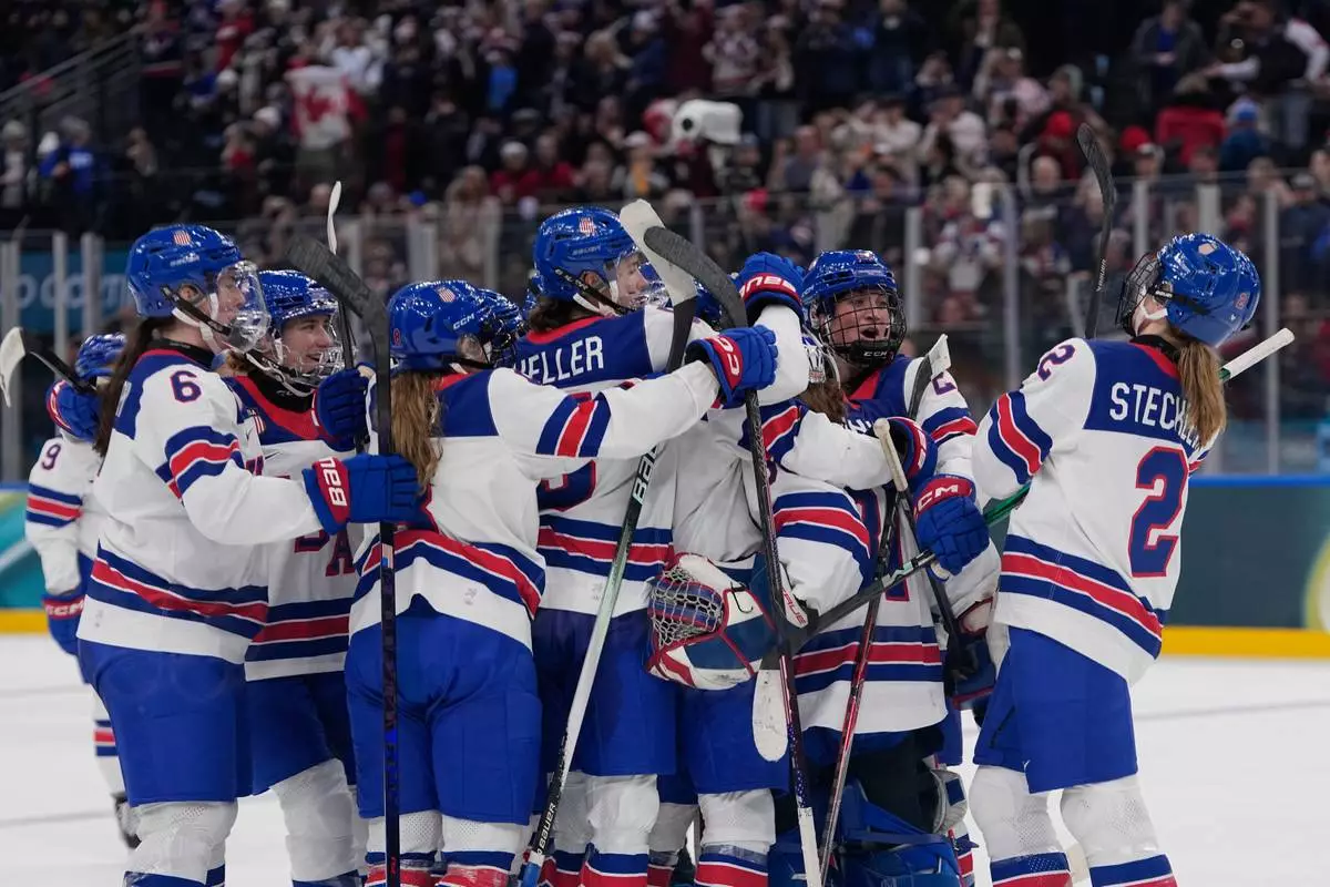 US players celebrate at the end of a preliminary round match of women's ice hockey between USA and Canada at the 2026 Winter Olympics, in Milan, Italy, Tuesday, Feb. 10, 2026. (AP Photo/Petr David Josek)
