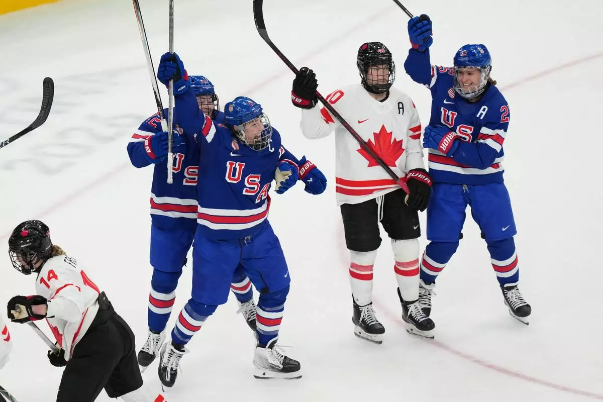 United States' Hilary Knight, center, celebrates after scoring a goal against Canada during the third period of the women's ice hockey gold medal game at the 2026 Winter Olympics, in Milan, Italy, Thursday, Feb. 19, 2026. (AP Photo/Carolyn Kaster)