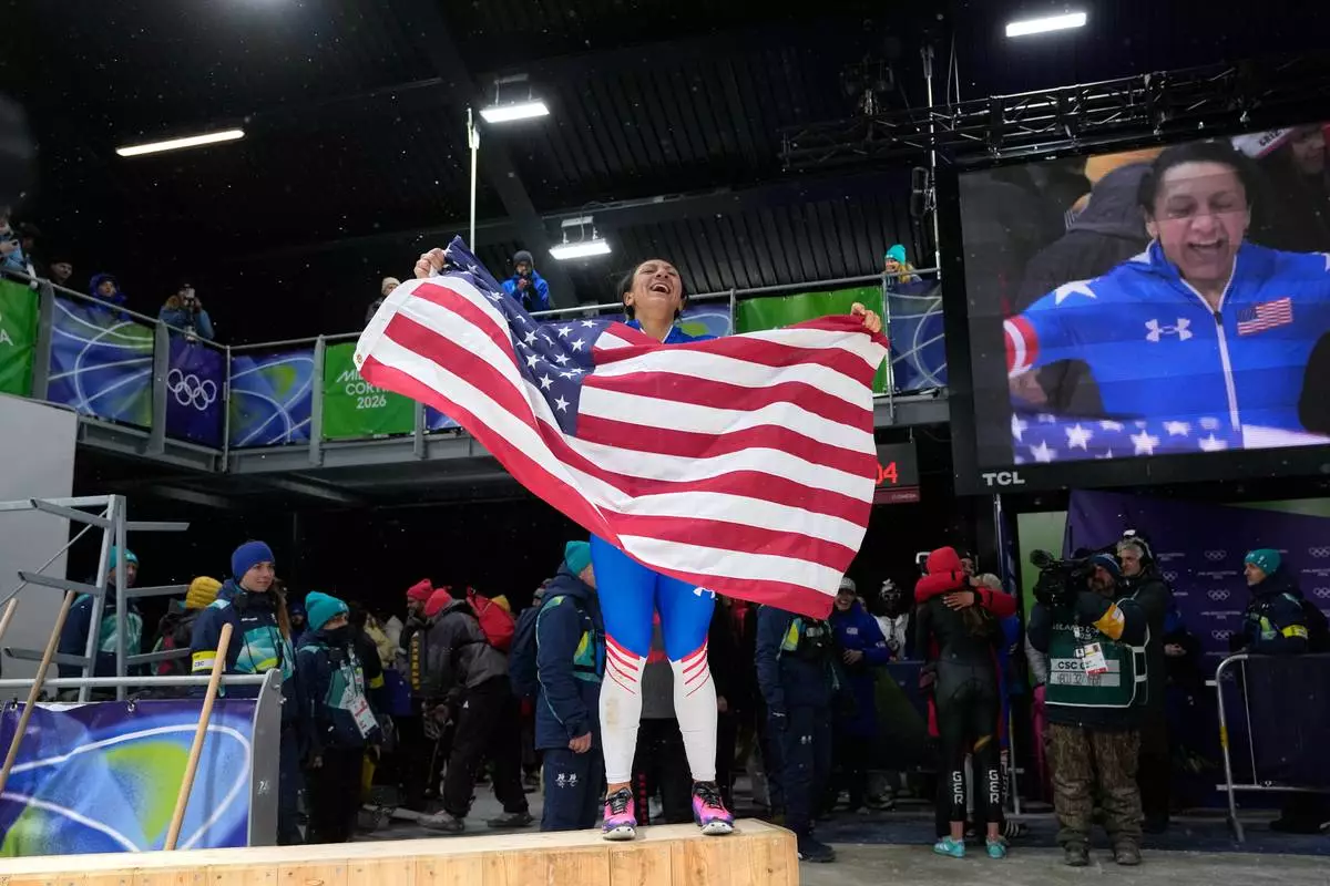 United States' gold medalist Elana Meyers Taylor celebrates at the finish after the women's monobob competition at the 2026 Winter Olympics, in Cortina d'Ampezzo, Italy, Monday, Feb. 16, 2026. (AP Photo/Alessandra Tarantino)