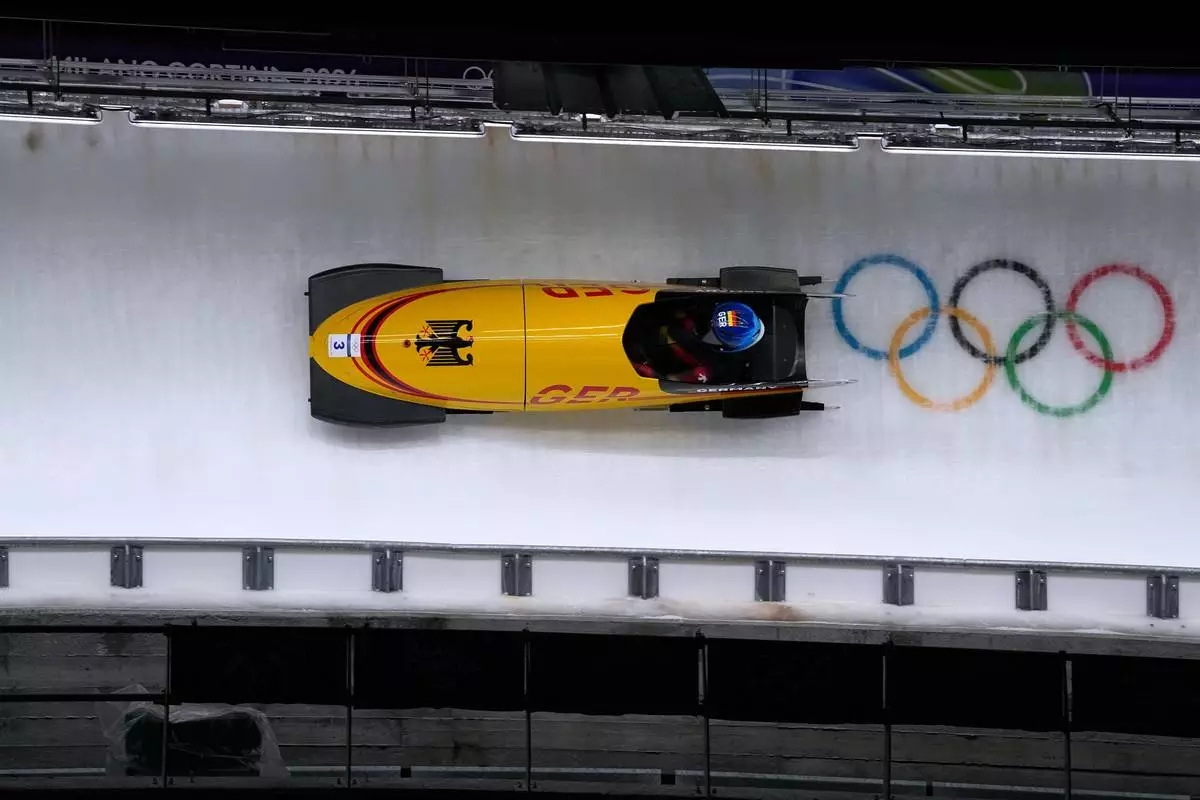 Germany's Lisa Buckwitz slides down the track during a women's monobob run at the 2026 Winter Olympics, in Cortina d'Ampezzo, Italy, Monday, Feb. 16, 2026. (AP Photo/Alessandra Tarantino)