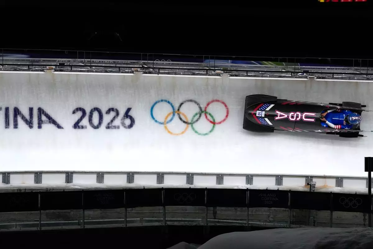 United States' Elana Meyers Taylor slides down the track during a women's monobob run at the 2026 Winter Olympics, in Cortina d'Ampezzo, Italy, Monday, Feb. 16, 2026. (AP Photo/Alessandra Tarantino)