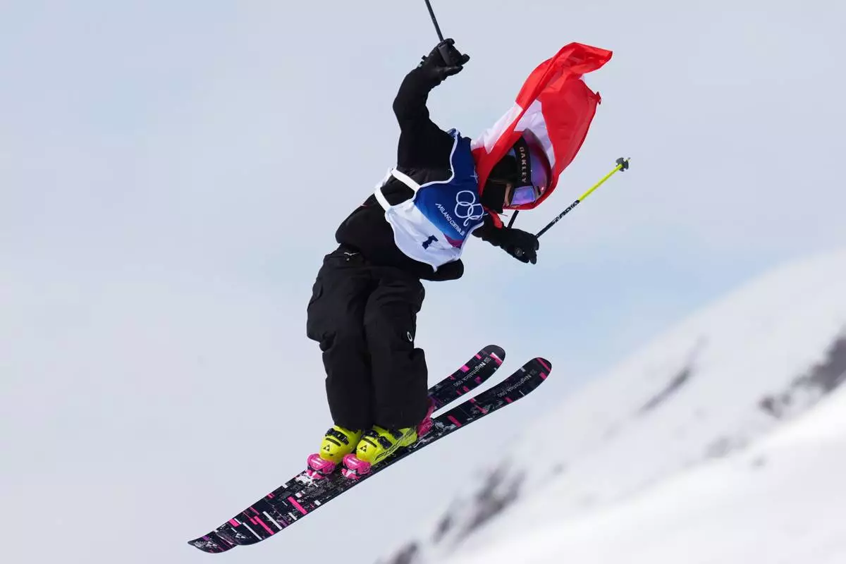 Switzerland's Mathilde Gremaud celebrates her gold medal on her final run in the women's freestyle skiing slopestyle finals at the 2026 Winter Olympics, in Livigno, Italy, Monday, Feb. 9, 2026. (AP Photo/Abbie Parr)