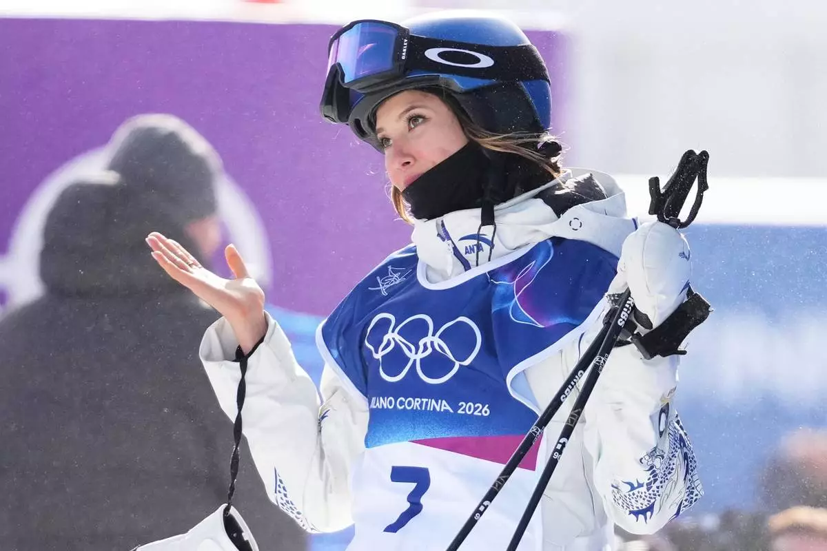 China's Eileen Gu reacts after crashing during the women's freestyle skiing slopestyle finals at the 2026 Winter Olympics, in Livigno, Italy, Monday, Feb. 9, 2026. (AP Photo/Lindsey Wasson)