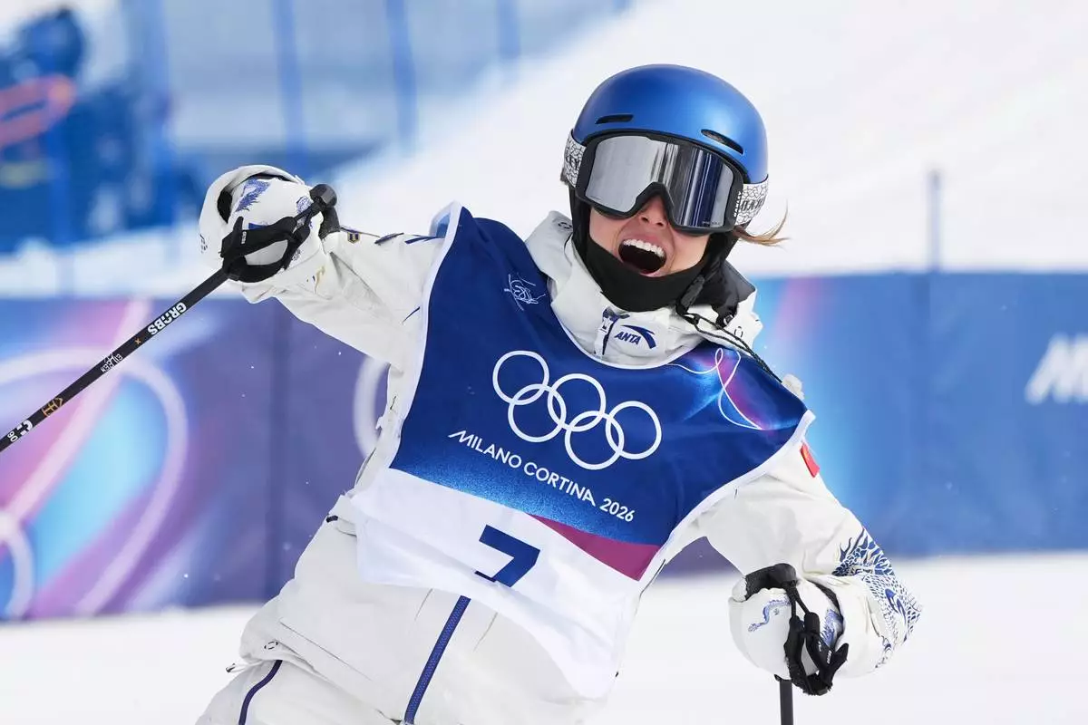 China's Eileen Gu celebrates during the women's freestyle skiing slopestyle finals at the 2026 Winter Olympics, in Livigno, Italy, Monday, Feb. 9, 2026. (AP Photo/Gregory Bull)
