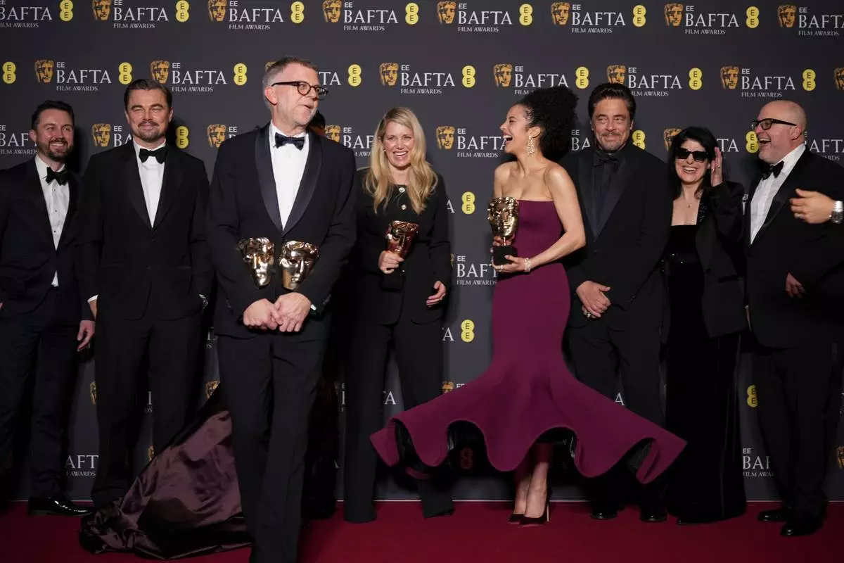 Andy Jurgensen, from left, Leonardo DiCaprio, Teyana Taylor, Paul Thomas Anderson, Sara Murphy, Chase Infiniti, Benicio Del Toro, Cassandra Kulukundis, and Michael Bauman pose with the awards for best director, cinematography, and adapted screenplay for 'One Battle After Another' at the 79th British Academy Film Awards, BAFTA's, in London, Sunday, Feb. 22, 2026. (AP Photo/Alastair Grant)