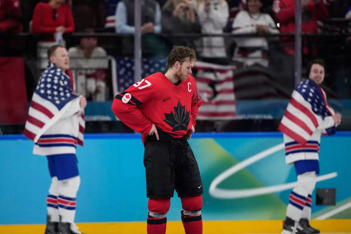 Canada's Connor McDavid (97) reacts after Canada lost to the United States in a men's ice hockey gold medal game between Canada and the United States at the 2026 Winter Olympics, in Milan, Italy, Sunday, Feb. 22, 2026. (AP Photo/Petr David Josek)