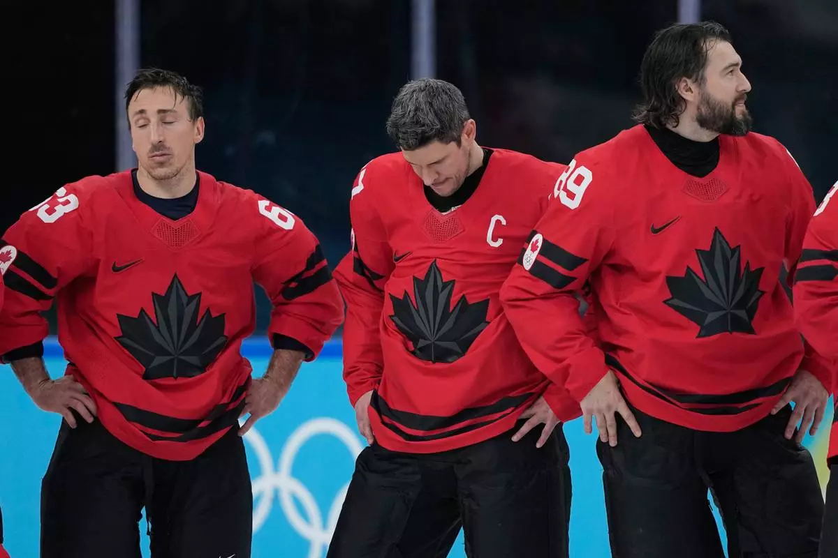 Canada's Sidney Crosby, center, reacts with teammates after losing to the United States in a men's ice hockey gold medal game between Canada and the United States at the 2026 Winter Olympics, in Milan, Italy, Sunday, Feb. 22, 2026. (AP Photo/Petr David Josek)