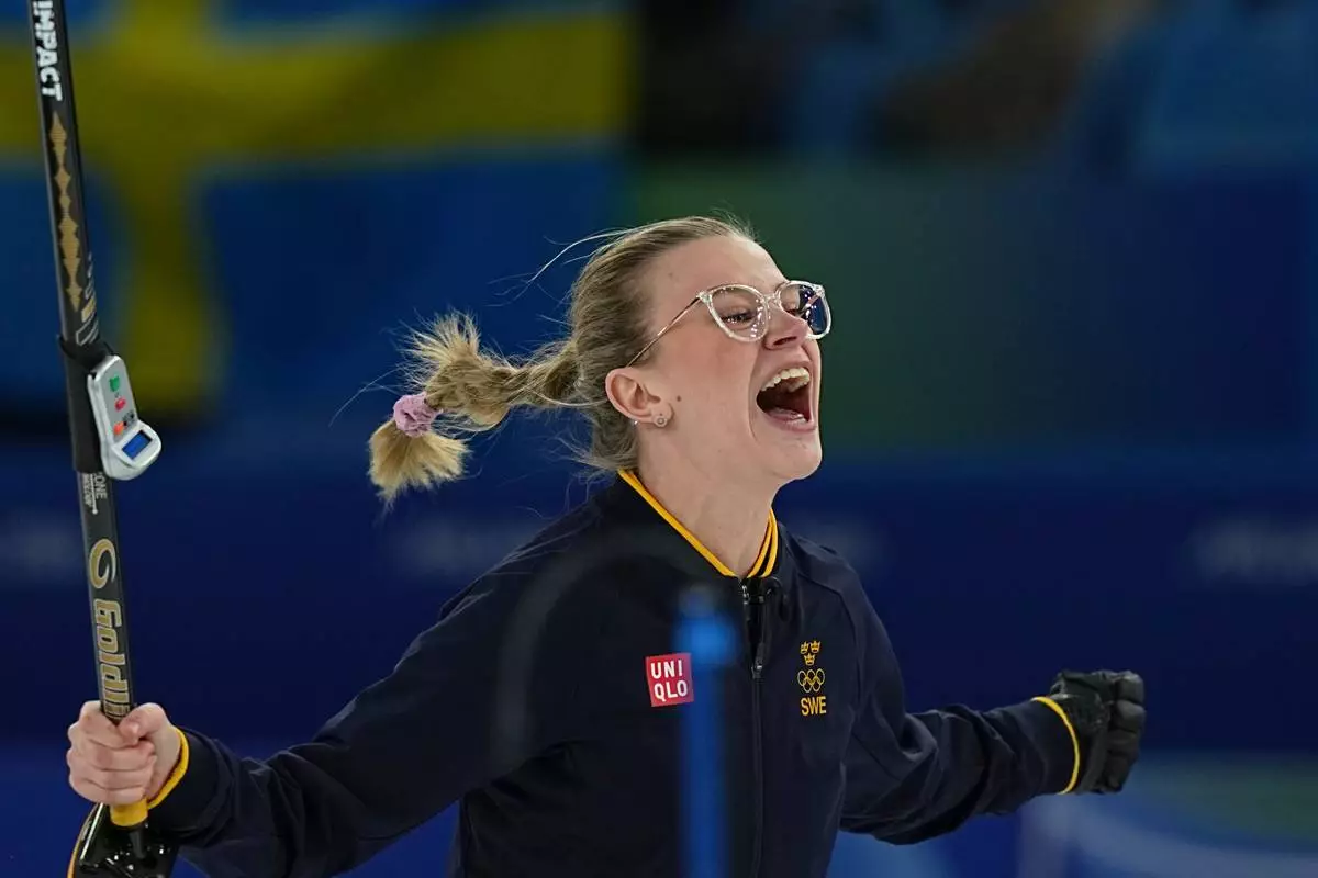 Sweden's Isabella Wranaa celebrates after winning the gold medal mixed doubles curling match against USA, at the 2026 Winter Olympics, in Cortina D'Ampezzo, Italy, Tuesday, Feb. 10, 2026. (AP Photo/Fatima Shbair)